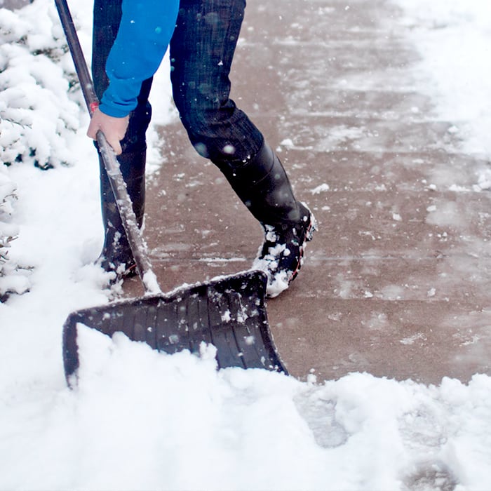 Person shoveling snow off of a driveway